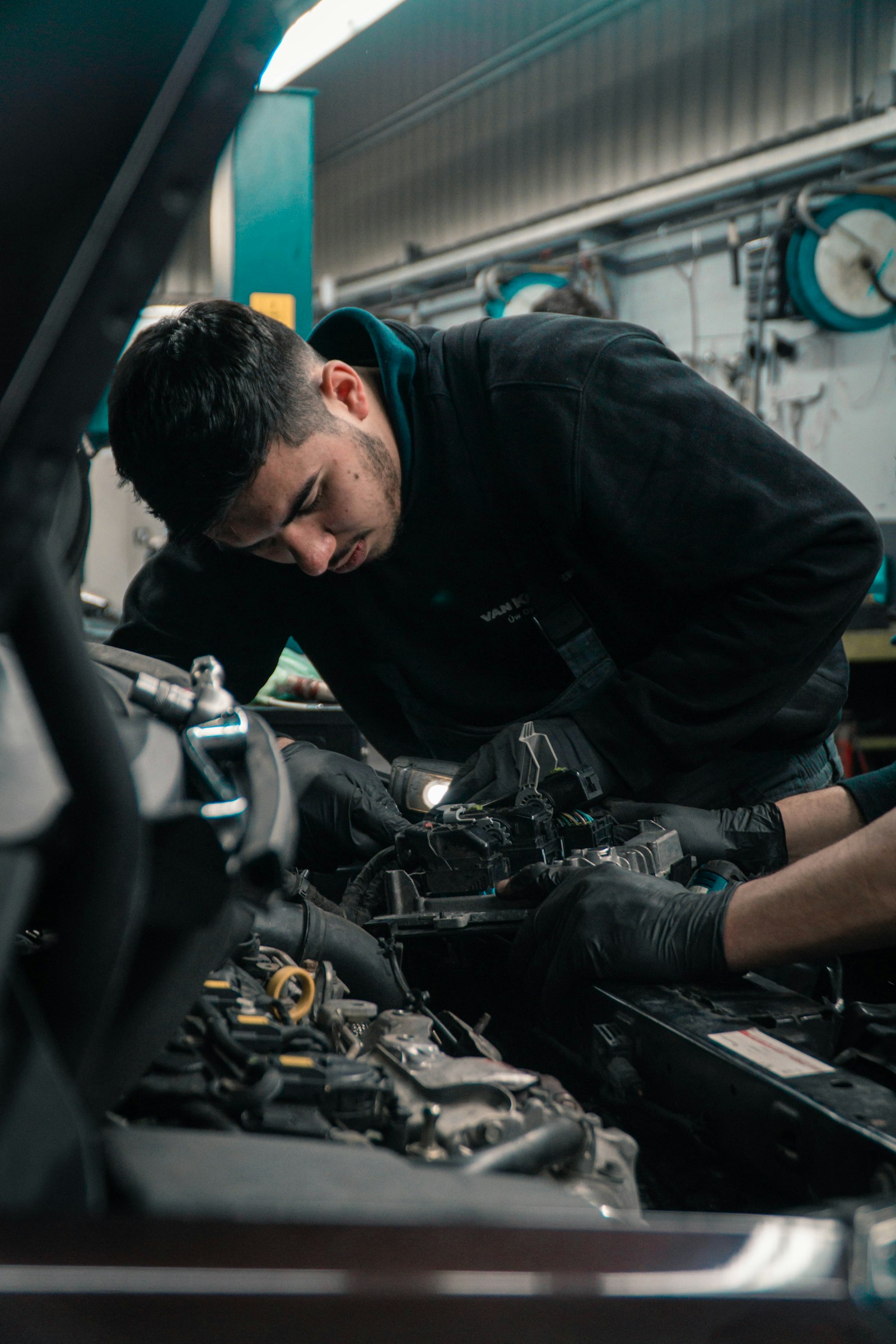 Mechanik při opravě rozebraného motoru v dílně